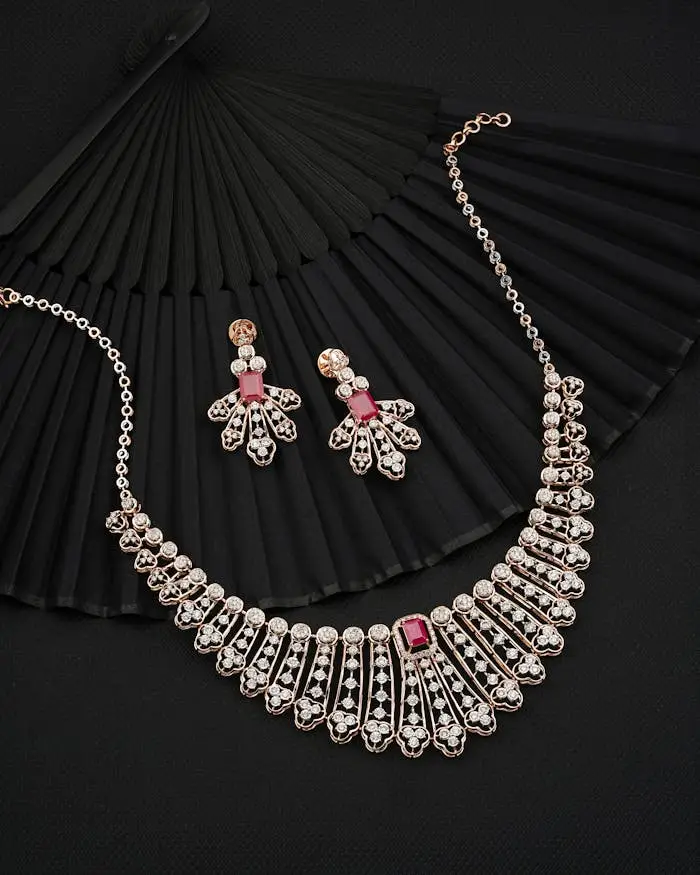 Luxury jewelry set with necklace and earrings on a black fan background.
