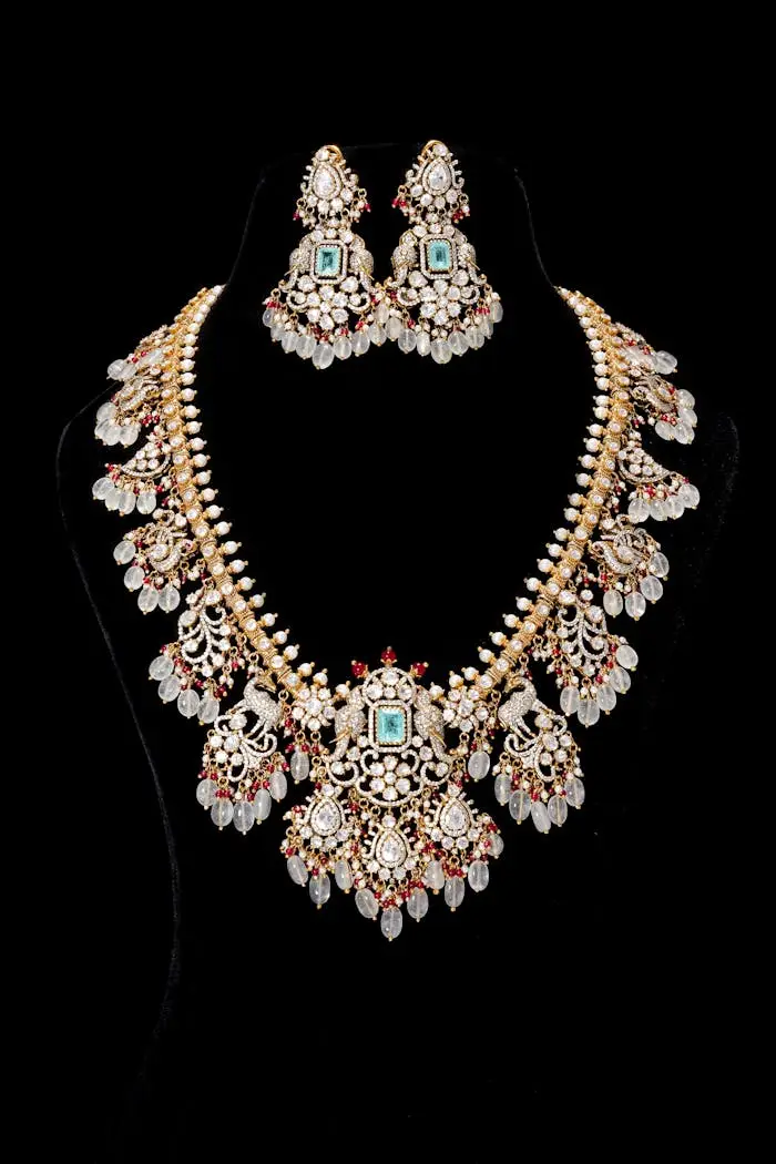 Luxurious ornate necklace and earring set with gemstones against black background.