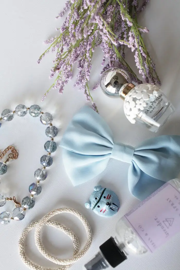 our-story Flat lay of lavender, bow, jewelry, and perfume creating an elegant arrangement on a white background.
